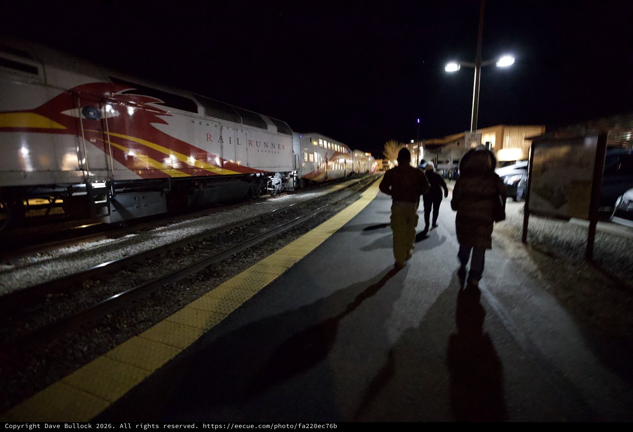 Passengers Boarding Rail Runner Express at Night