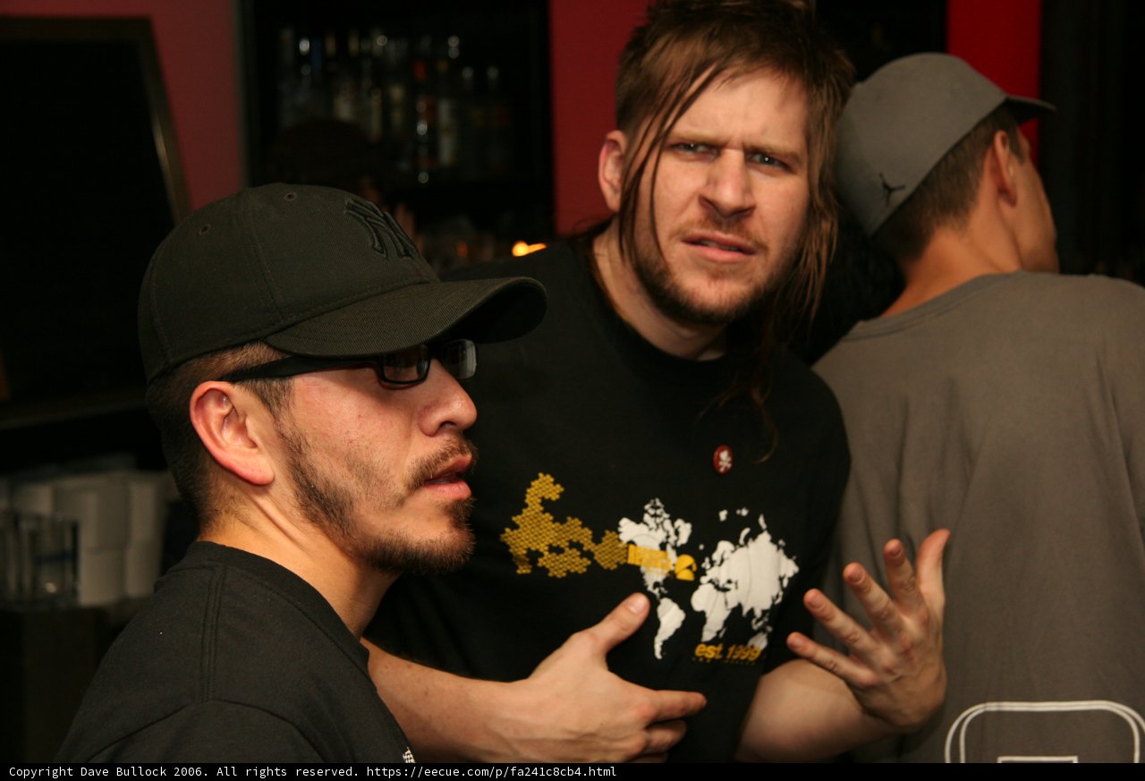 Two Men Enjoying Drinks at a Bar