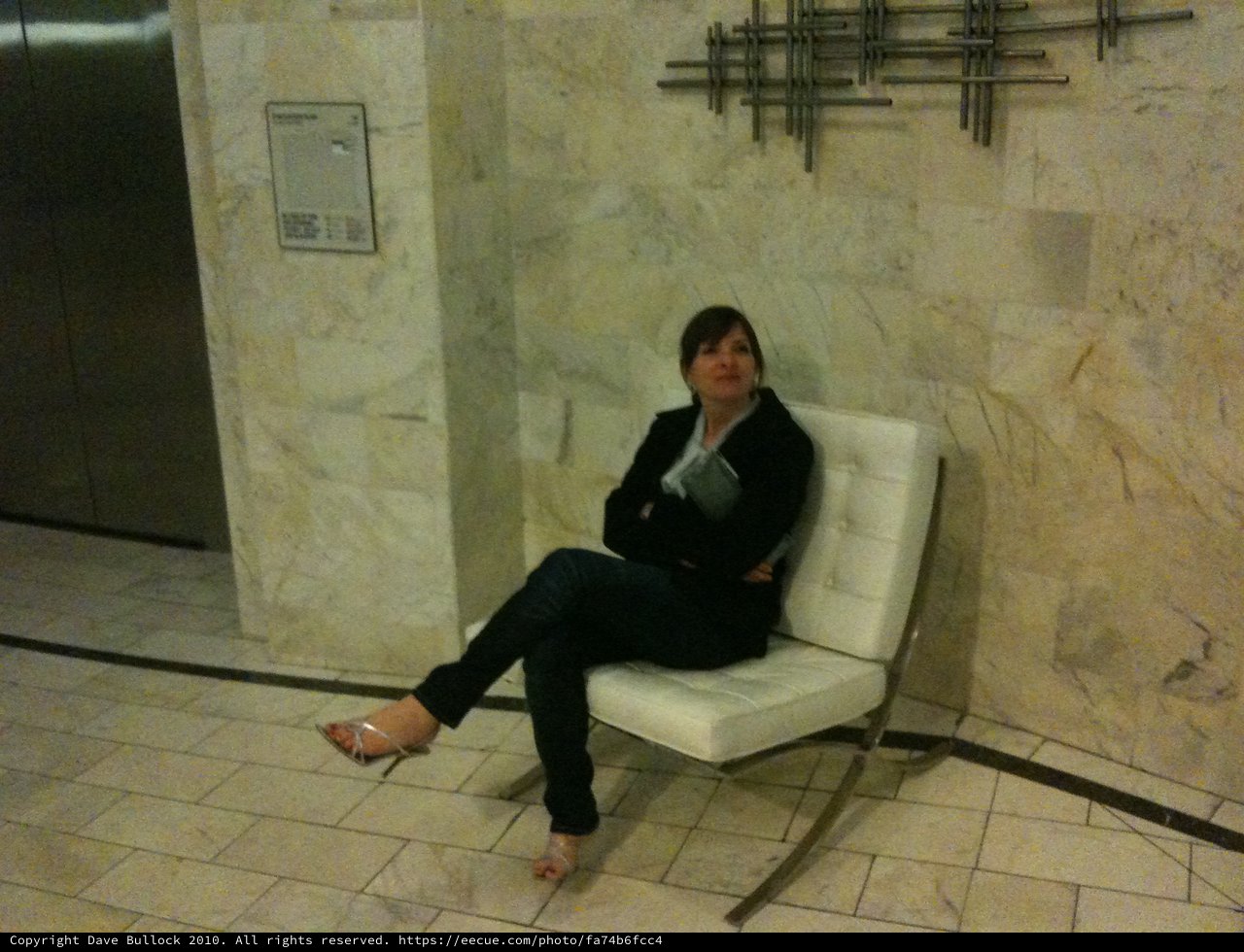 Woman Waiting Patiently in Modern Corporate Lobby