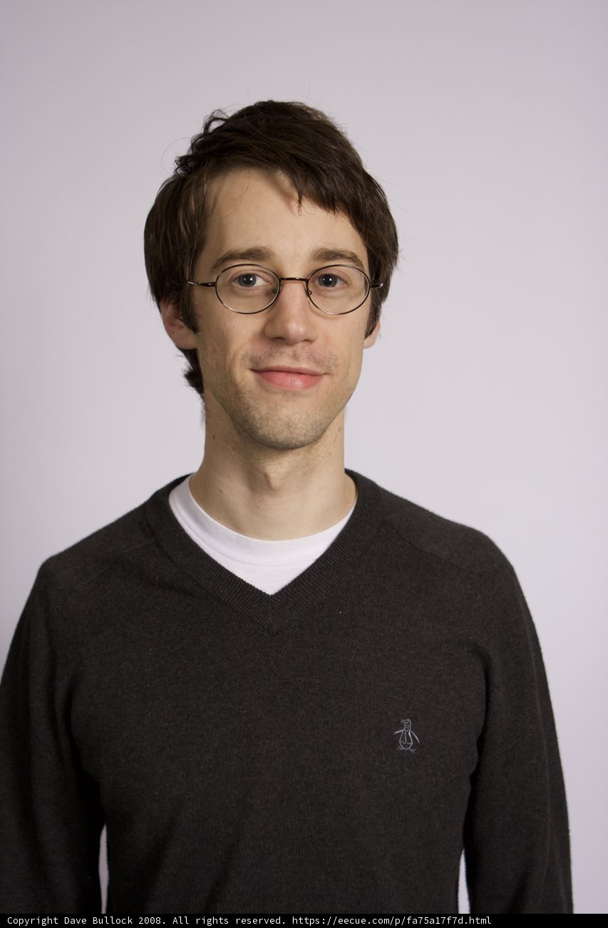 Portrait of a Happy Man in Glasses and a Sweater