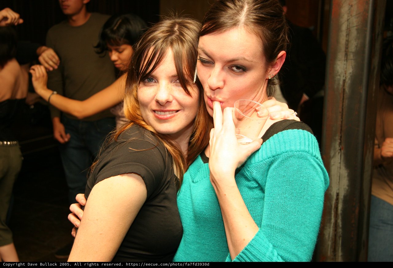 Two Friends Celebrate at a Nightclub Party