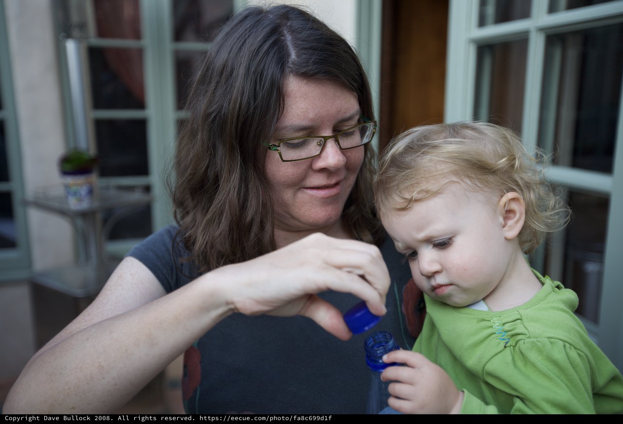 Mother and Toddler Sharing a Curious Moment Outdoors