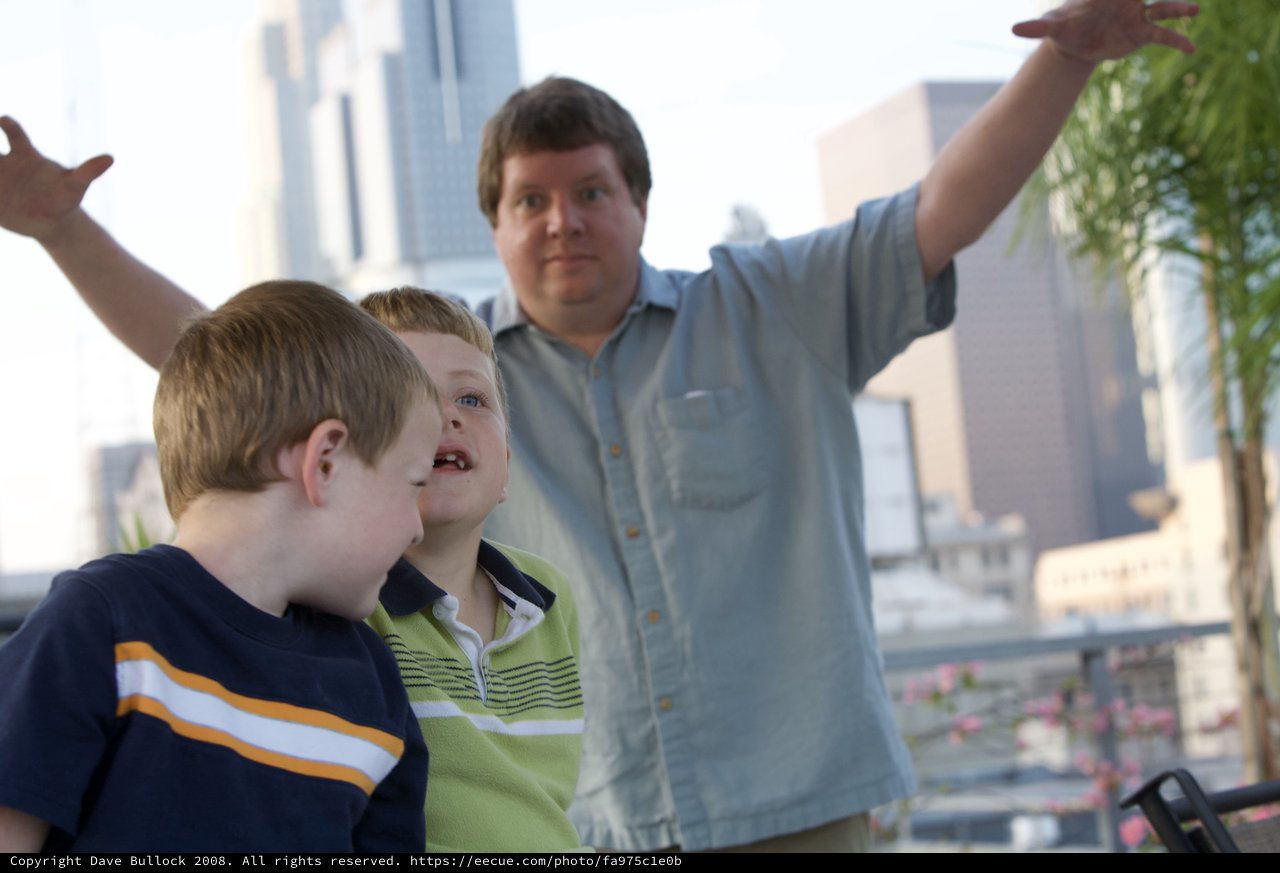 Father Points Out City Sights to Two Young Boys