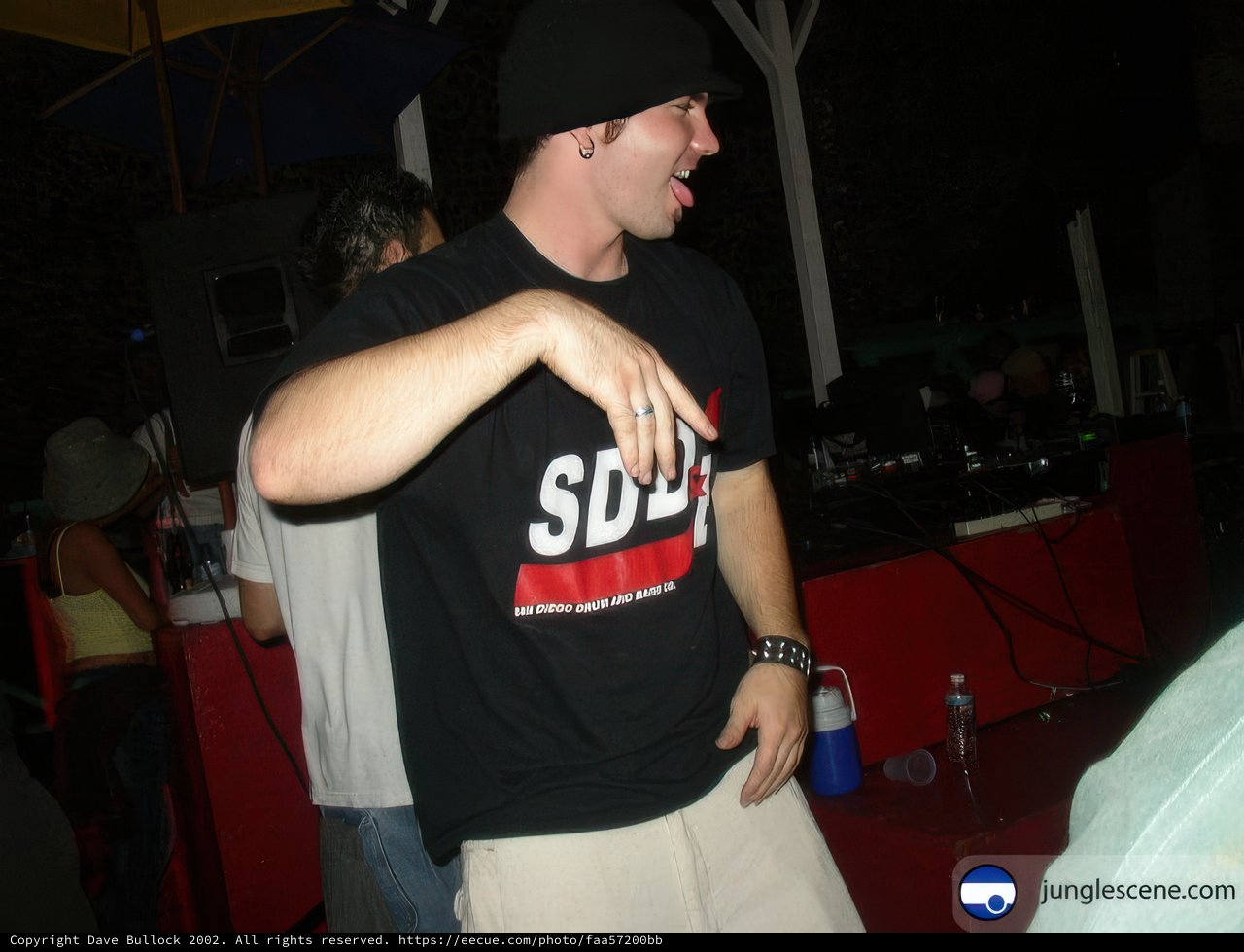 Partygoer in Black Shirt and Hat