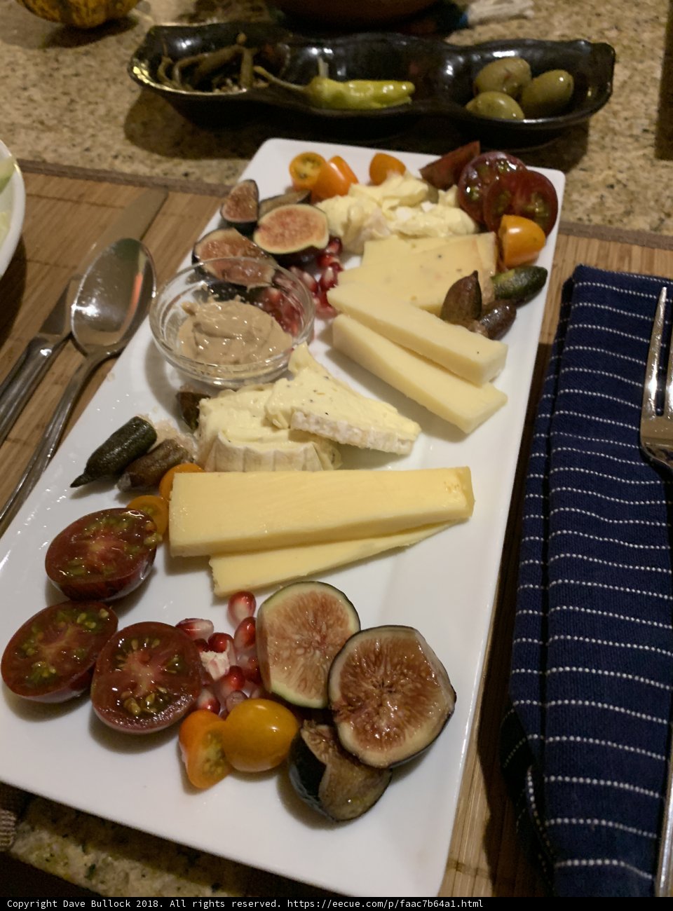 Antipasti Delight Caption: A plate of delicious antipasti consisting of cheese, tomatoes, and figs paired with a variety of savory meats and seasonings.