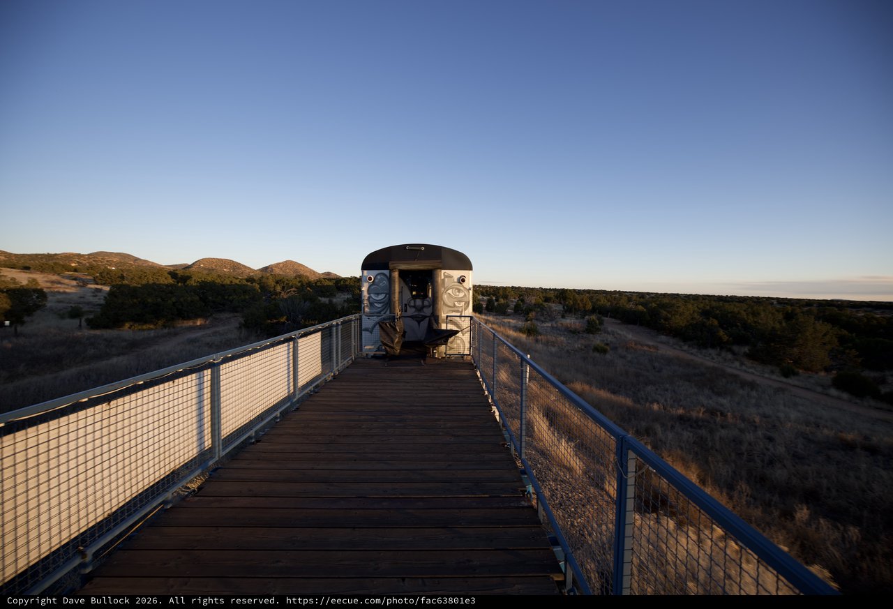 Wooden Boardwalk Leading to Desert Observation Structure at Dusk