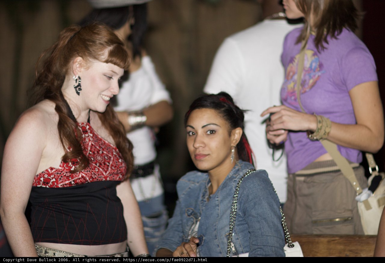 Red-haired woman and friends posing with luggage
