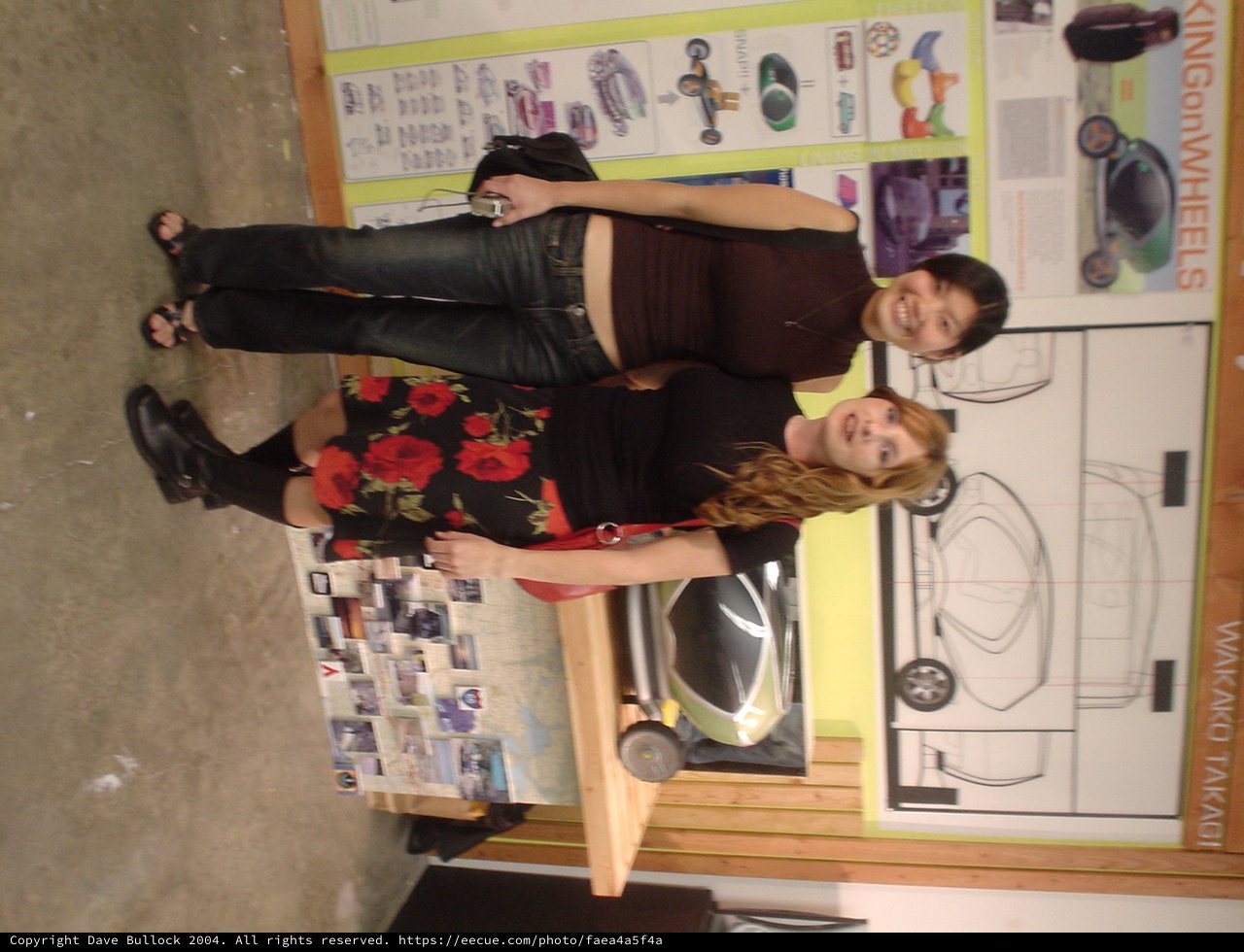 Two Women Posing at Art Exhibition Display