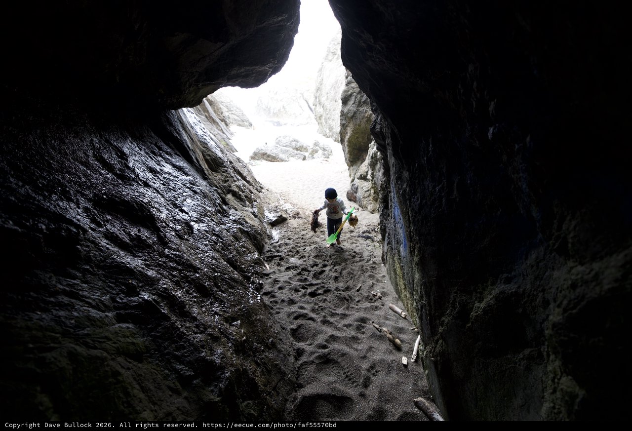 Young Explorer Ventures Into a Rocky Sea Cave