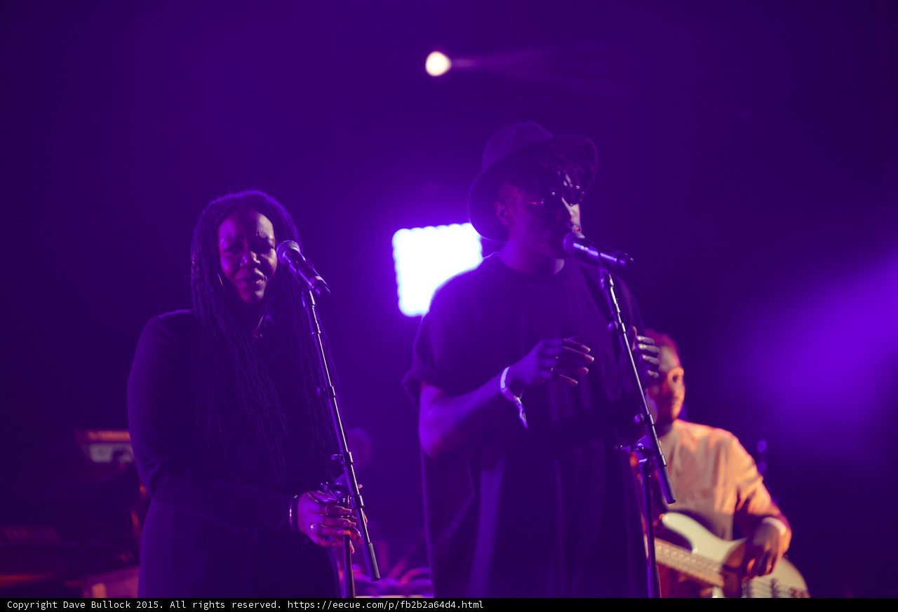 Solange Band Three Musicians Dreadlocks Hat Bassist Performing Purple
