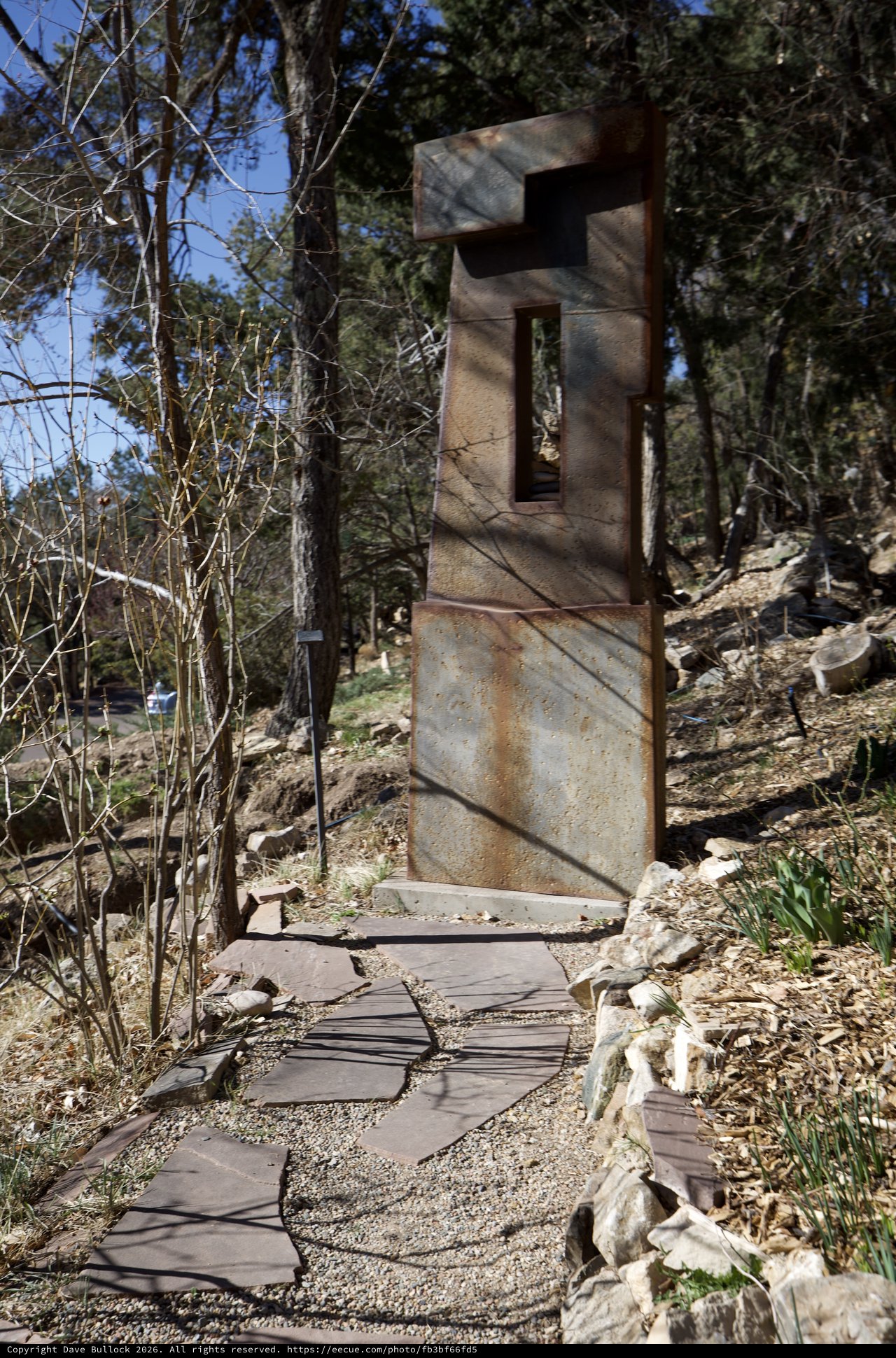 Weathered Metal Sculpture Gateway in Forest Garden
