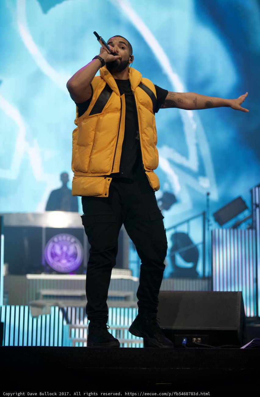 Solo Performance by Drake Caption: Entertainer Drake lights up the stage in his signature yellow vest during his solo performance at Coachella 2017, captivating the crowd with his music and powerful presence.