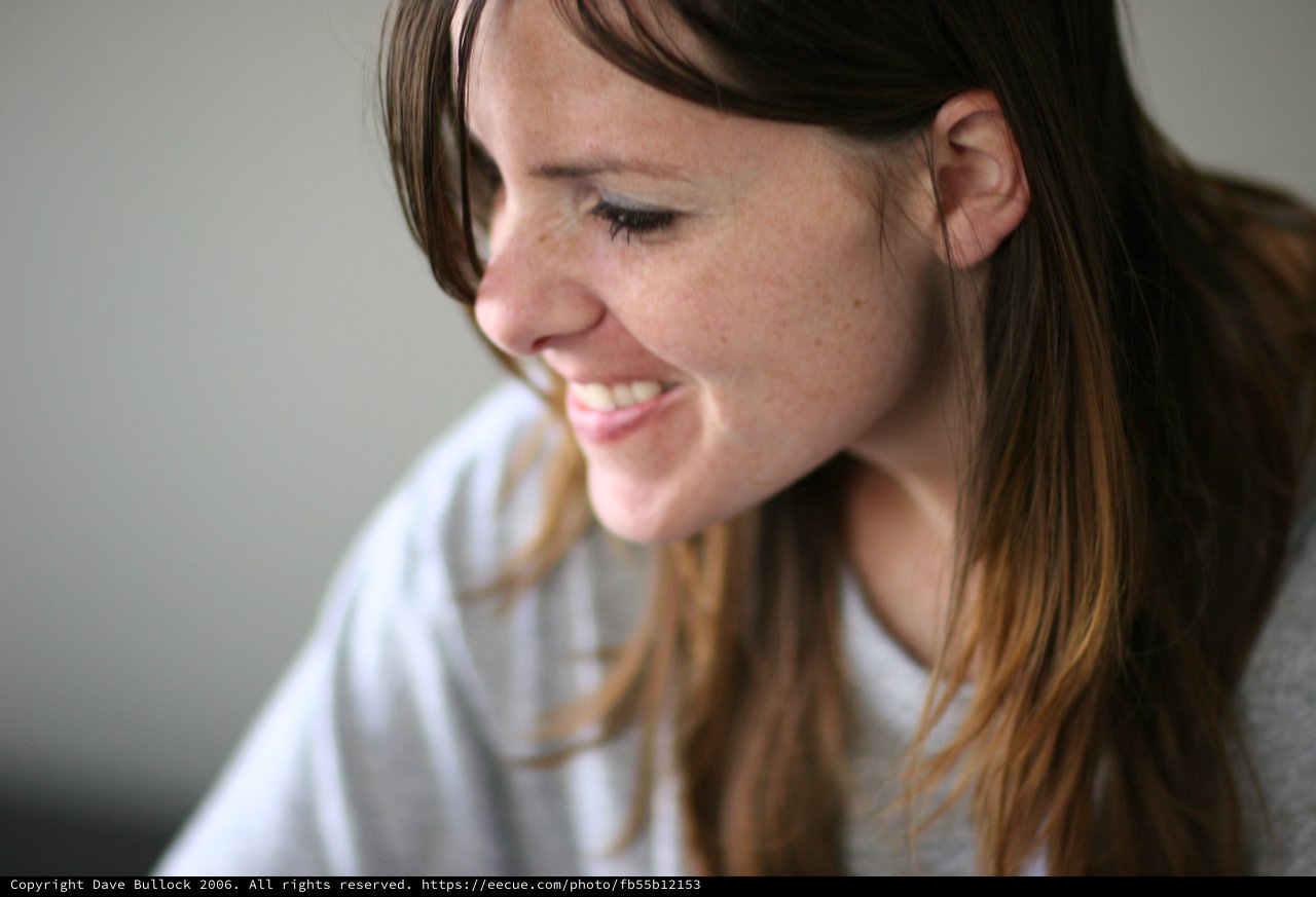 Candid Smile of a Young Woman Lost in Thought