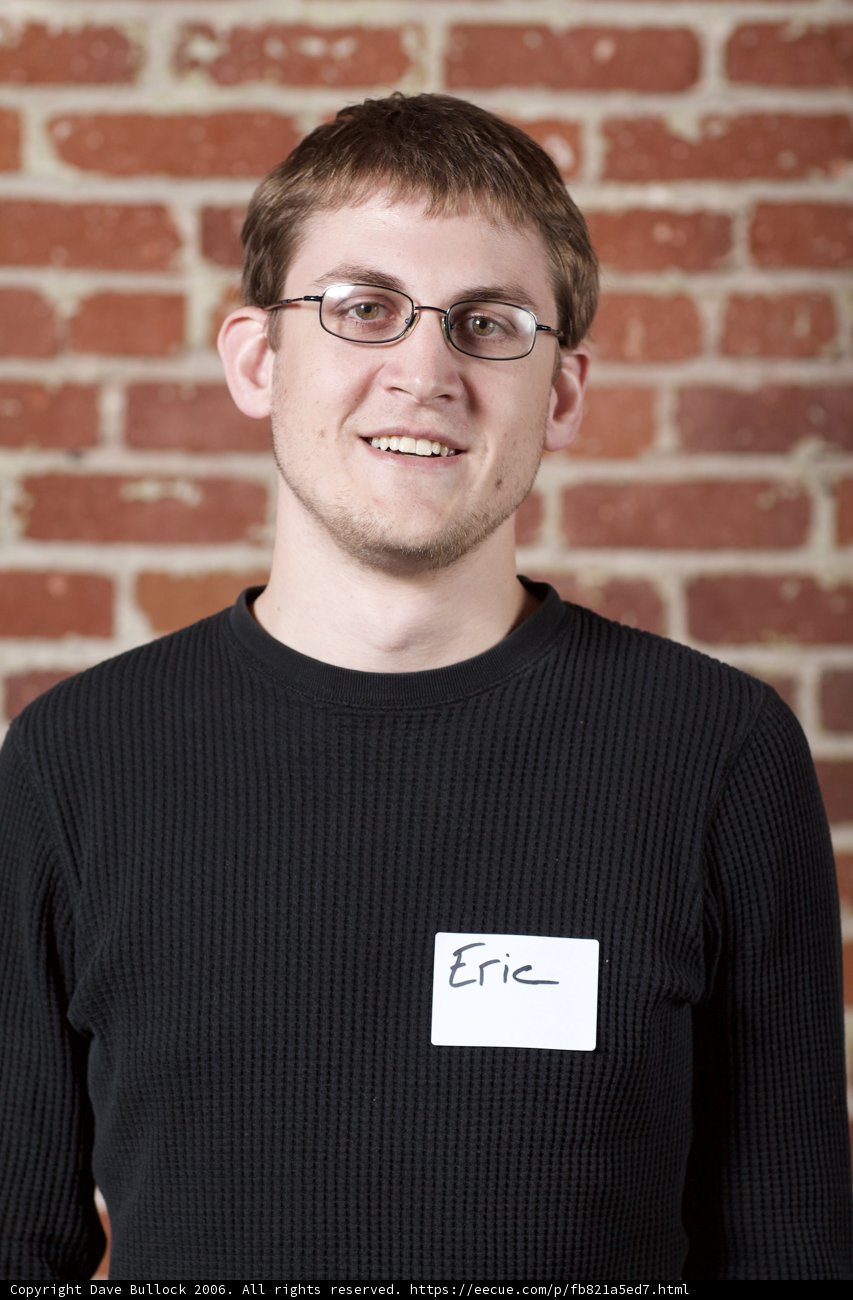 Aleksey Obmochaev in Black Sweater and White Name Tag