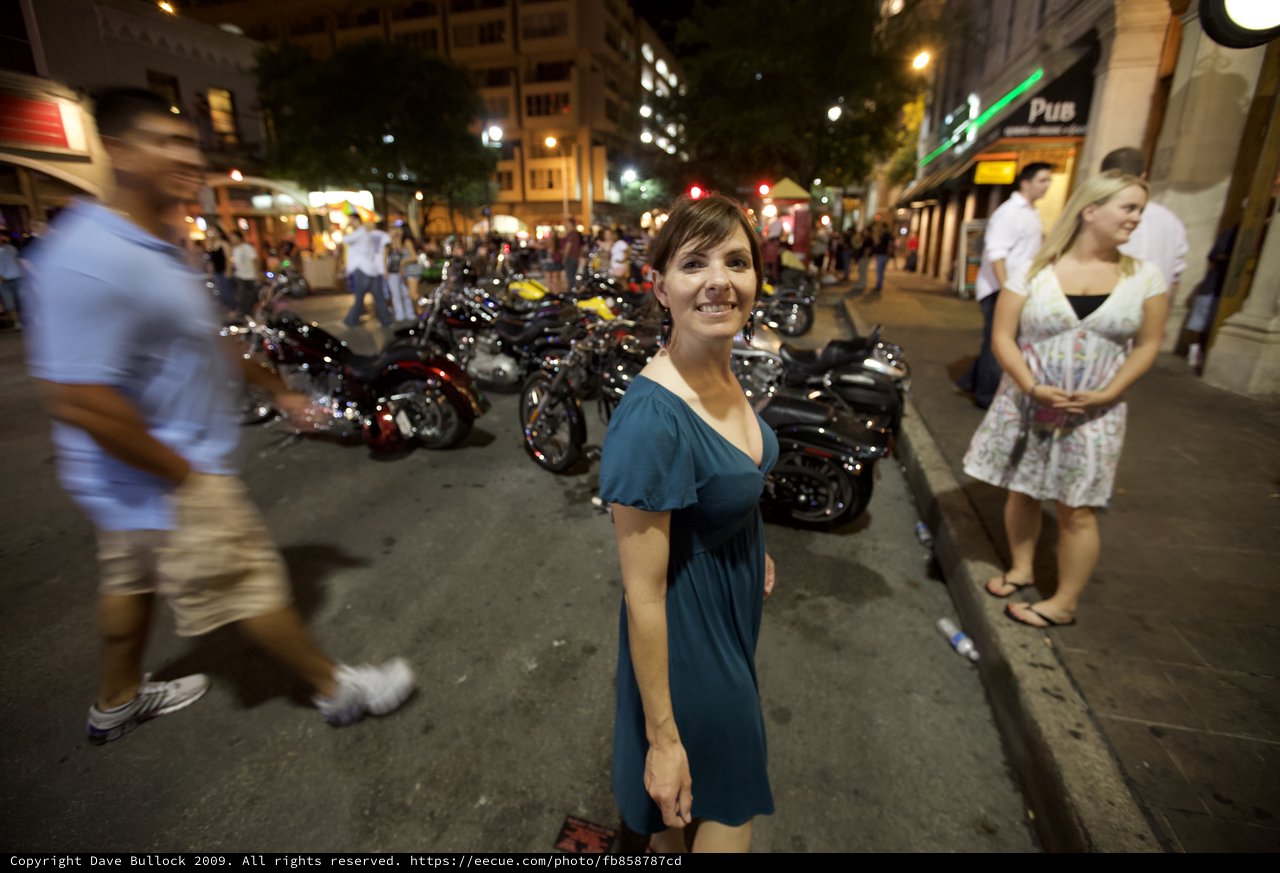Woman Smiling on Lively Austin Street at Night