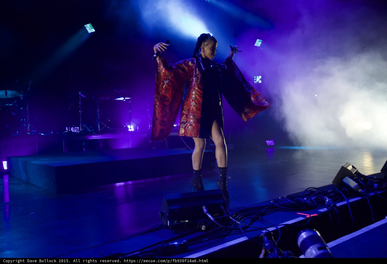 FKA twigs Stunning Full Body Arms Spread Wide Kimono Wings Red Brocade Gold Patterns Black Bodysuit Boots Expressive Hands Blue Purple Lighting