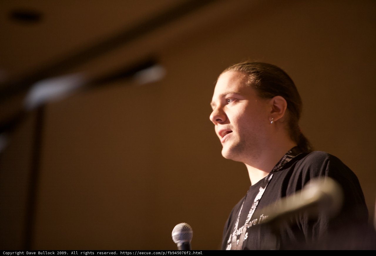 Rocking the Mic Caption: A long-haired man captivates the crowd with his electrifying speech at the 2009 Defcon 17 conference.