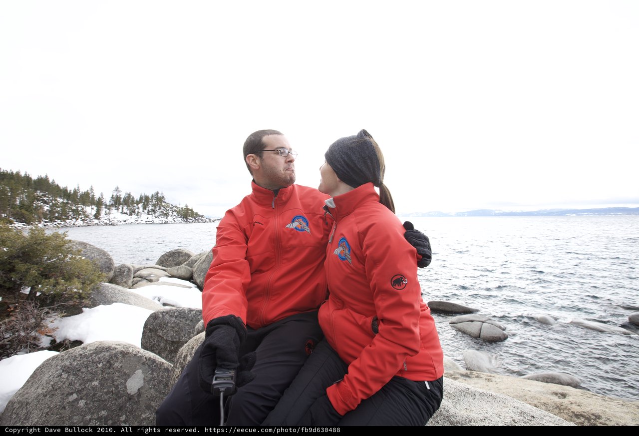 Couple in Matching Red Jackets at Snowy Lake Tahoe