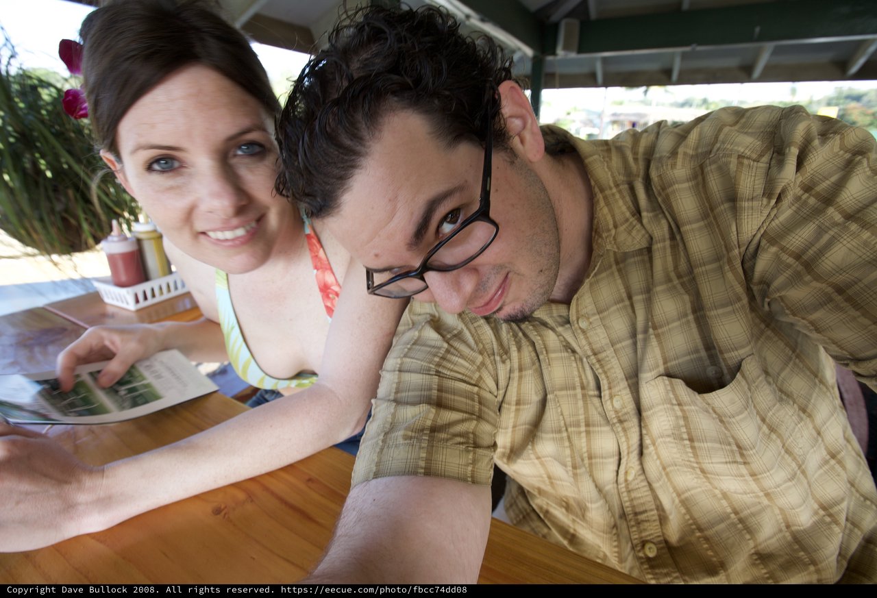 Couple Sharing a Menu at Hawaiian Outdoor Restaurant