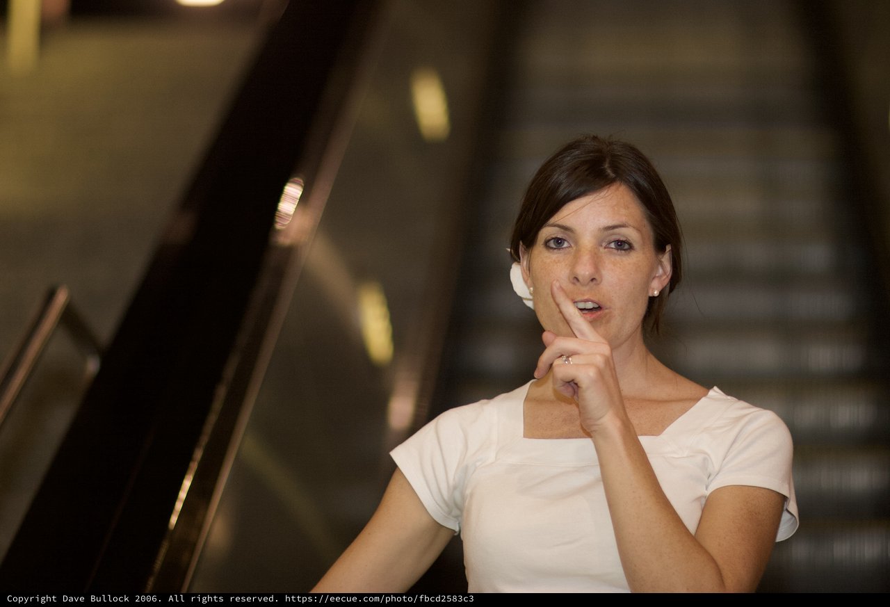 Thoughtful Woman Pausing on Escalator in Modern Interior