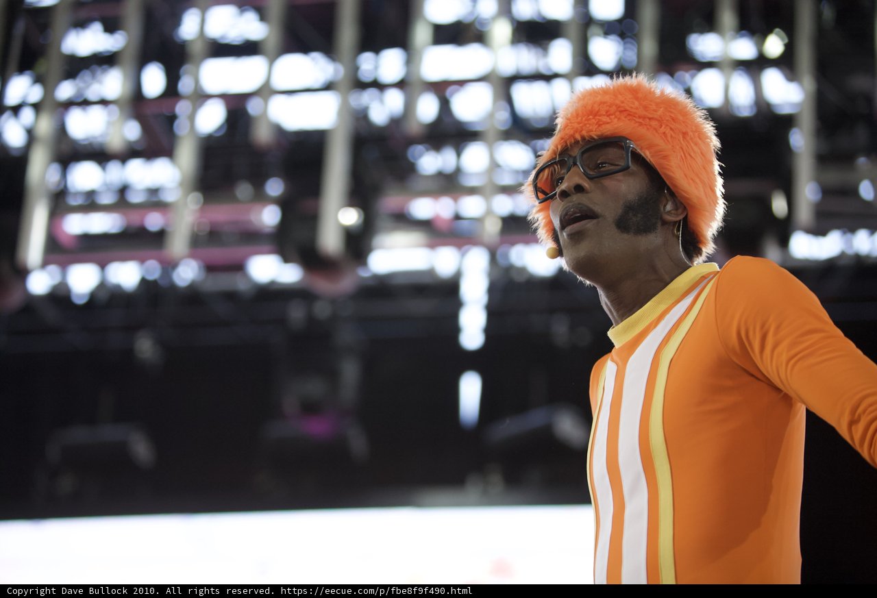 Orange-clad Lance Robertson on stage