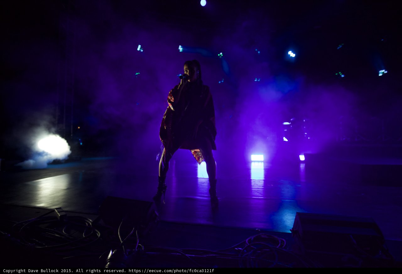 FKA twigs Full Body Wide Silhouette Legs Apart Singing Microphone Kimono Flowing Red Brocade Black Bodysuit Boots Spotlight Heavy Atmospheric Haze