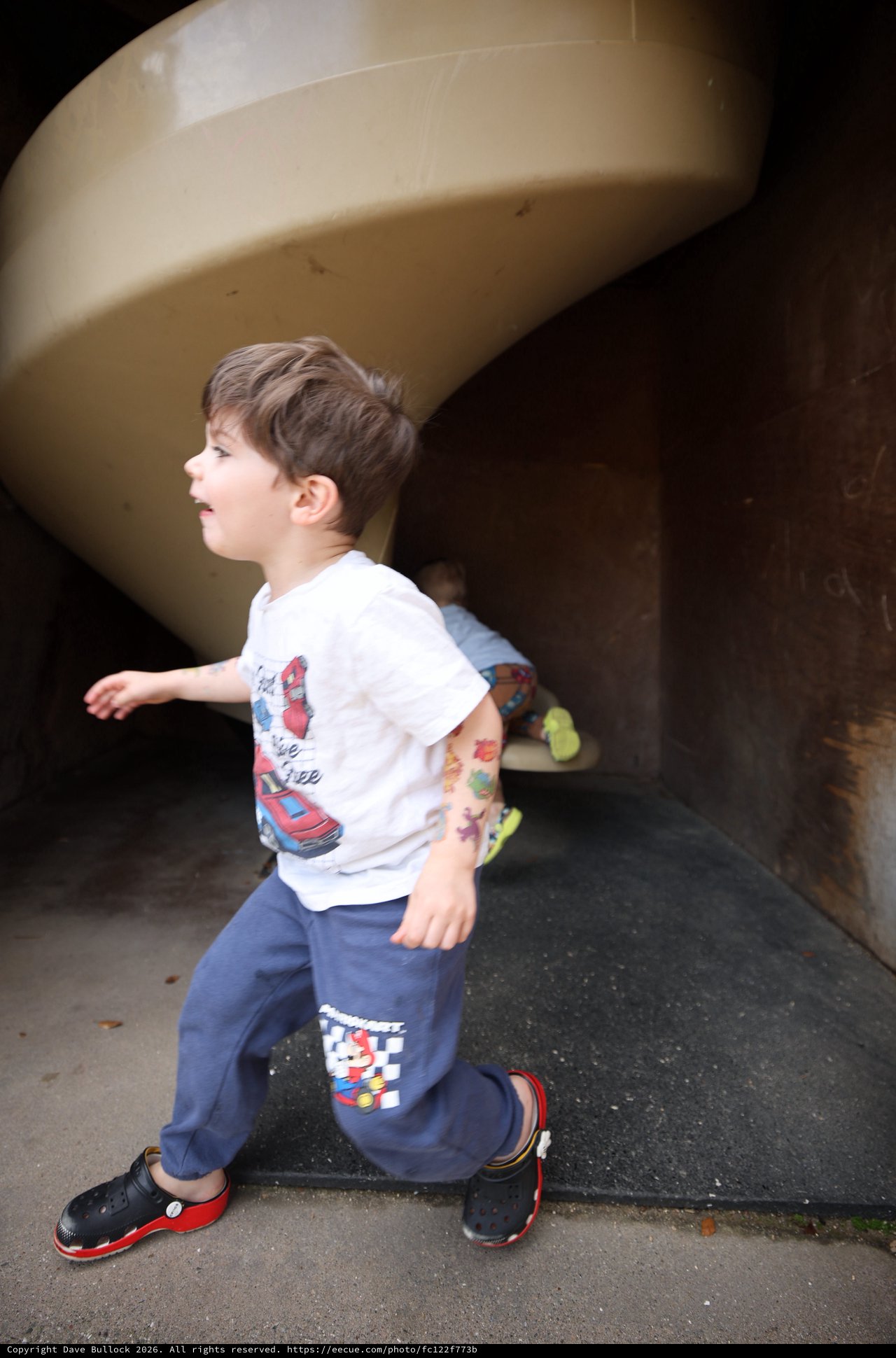 Young Boy Running Through Tunnel at Fantasyland