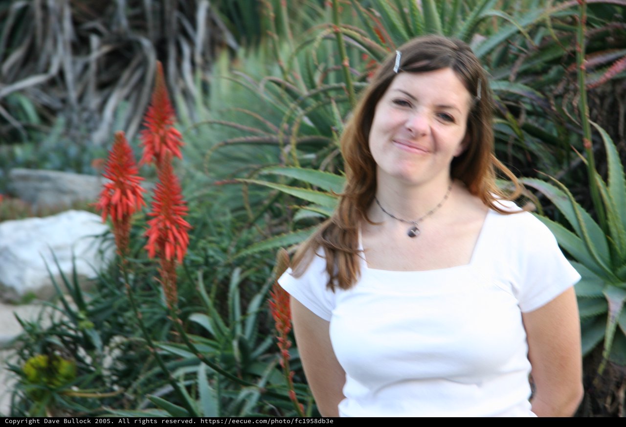 Young Woman Smiling Among Desert Garden Blooms
