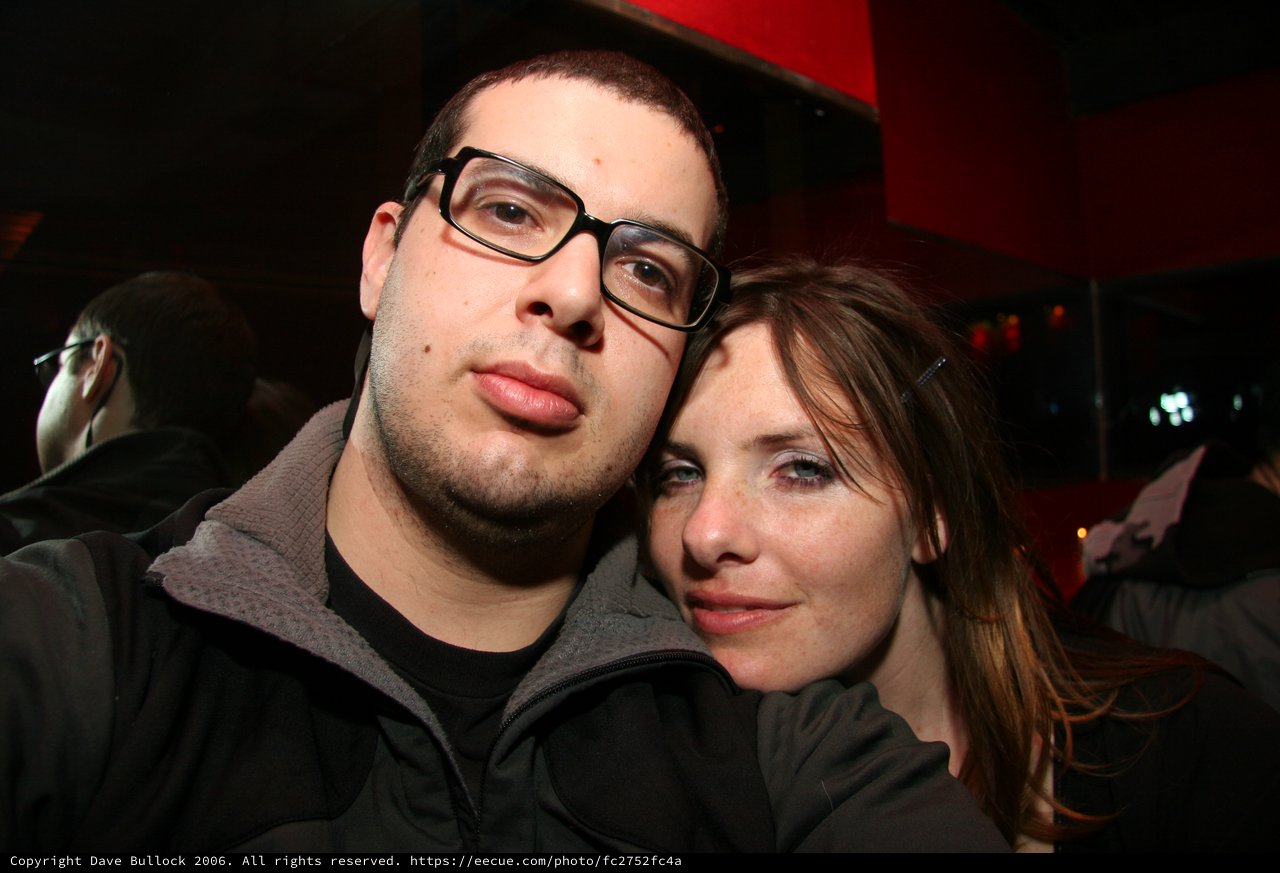 Two Friends Pose at a Dimly Lit Nightclub