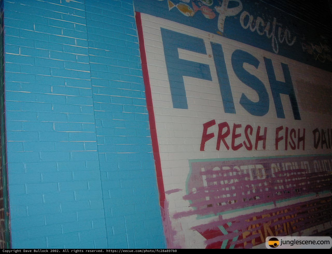 Fresh Fish Advertisement on Brick Wall