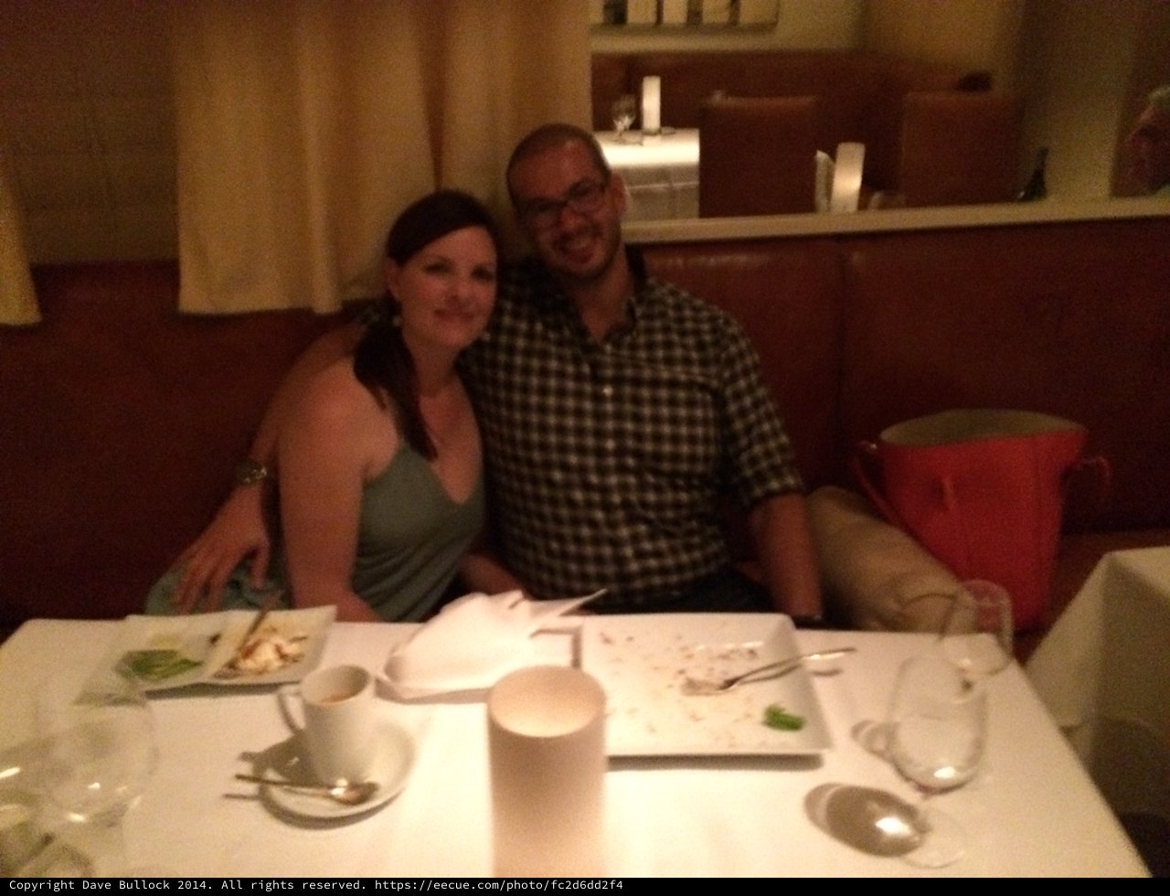 Couple Smiling Together at Restaurant Dinner Table