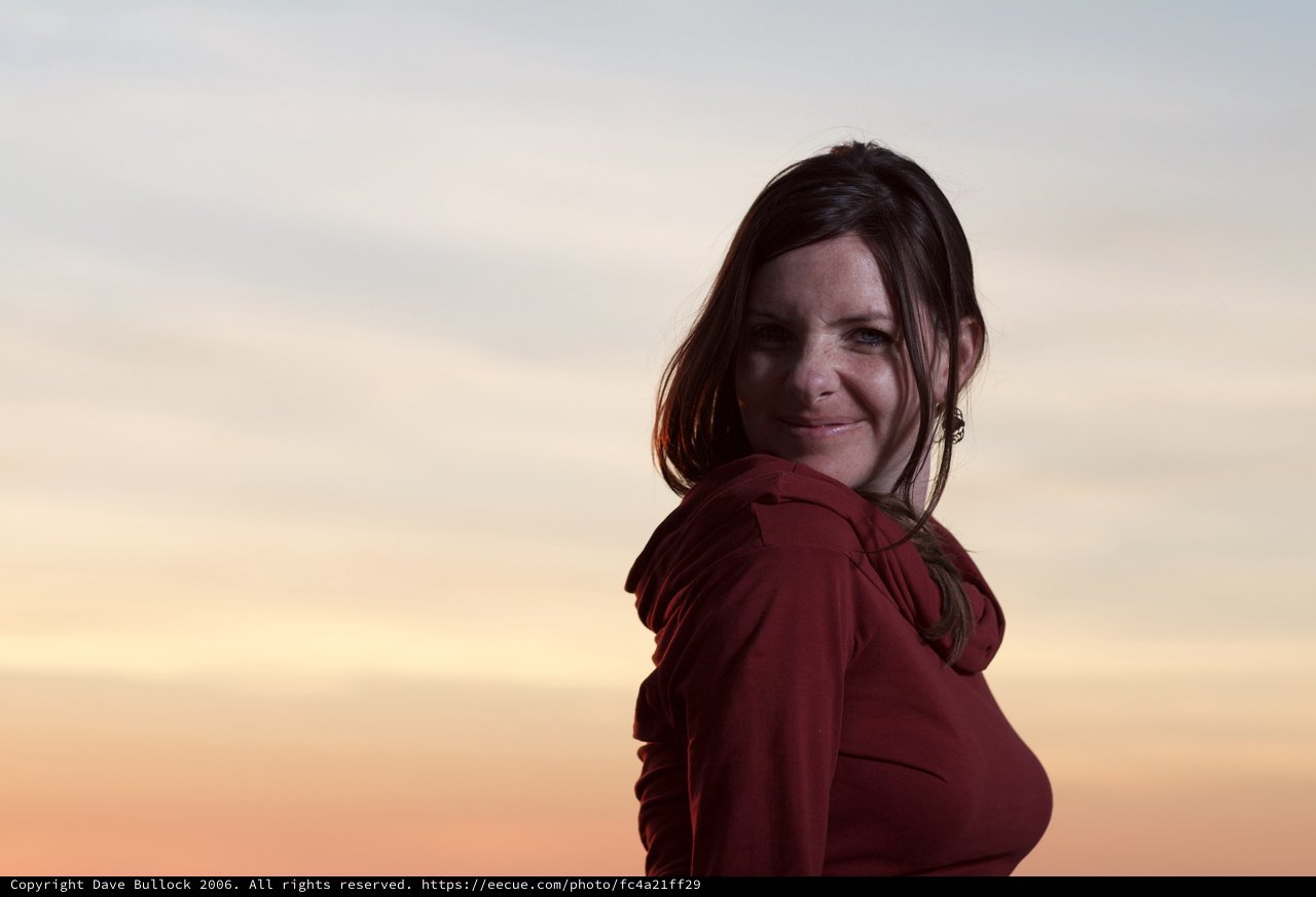 Woman in Red Smiling at Golden Hour Sunset