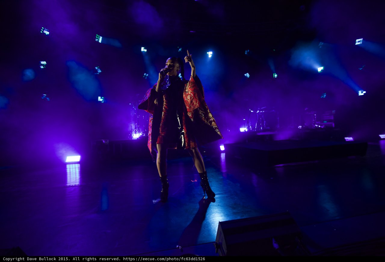 FKA twigs Full Body Arm Raised Finger Pointing Singing Powerfully Kimono Flowing Interior Black Bodysuit Boots Blue Purple Lighting Heavy Haze