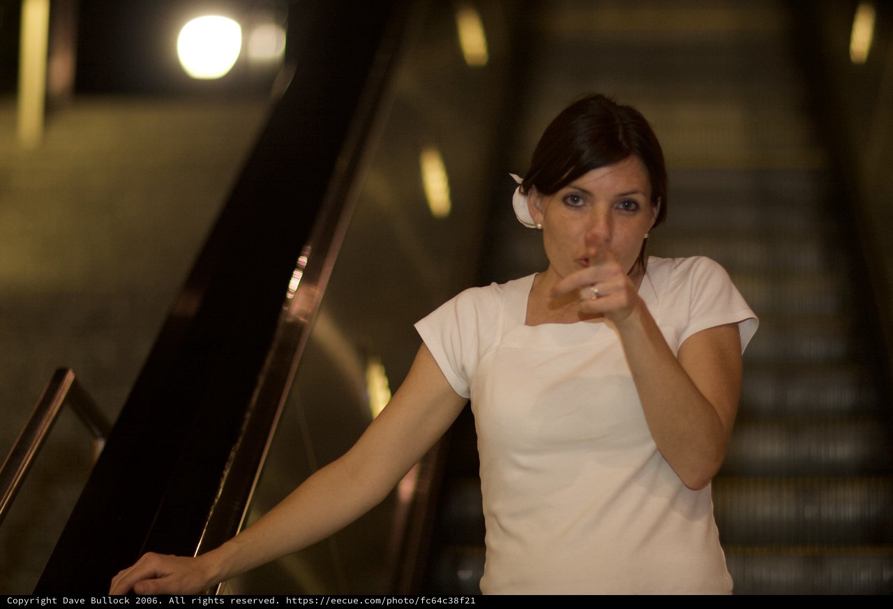 Bride on Escalator Drinking at Night Event