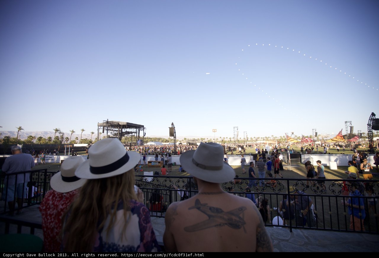 Hat-Wearing Crowd Watches Plane Soar