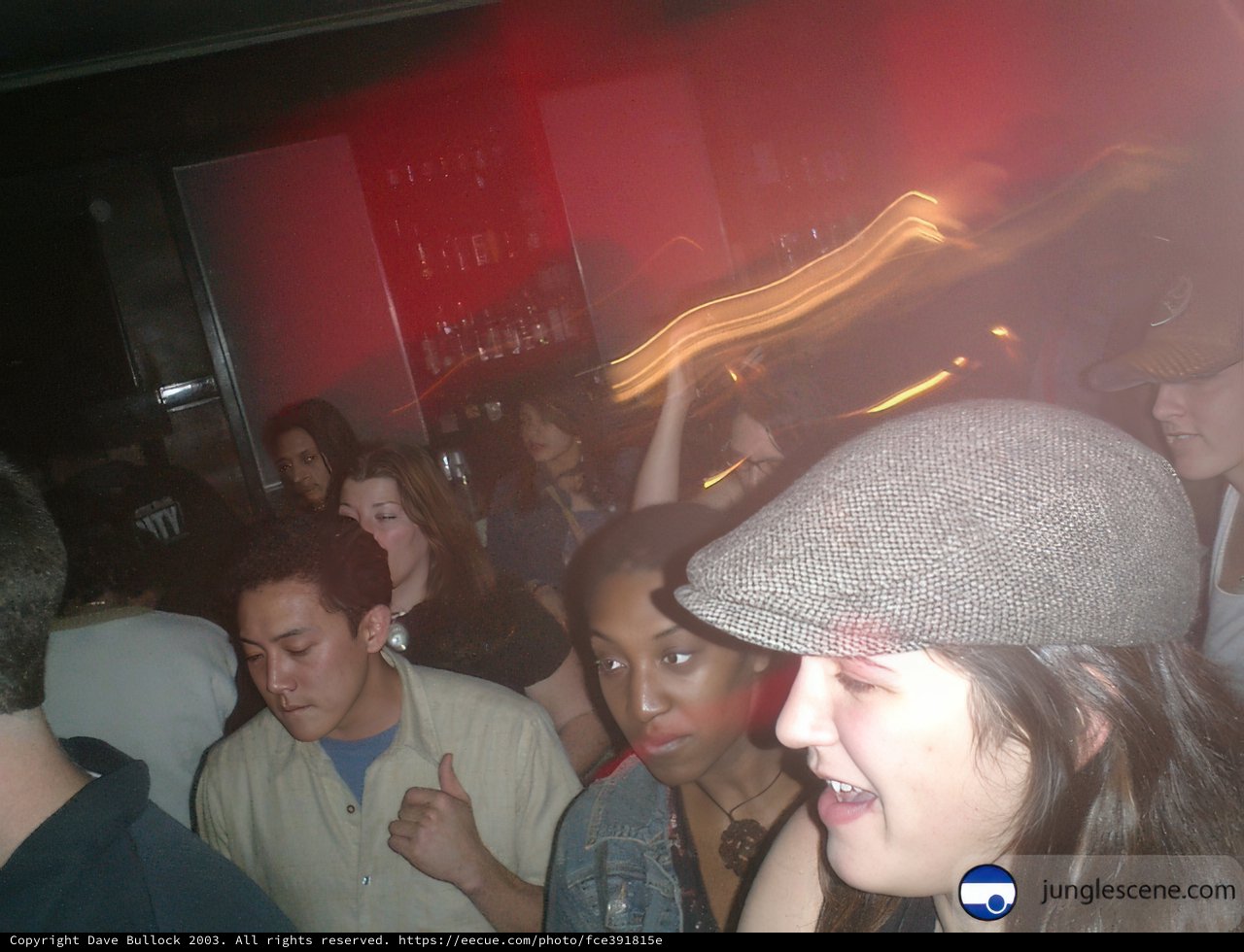 Nightclub Party with Hat-Wearing Man