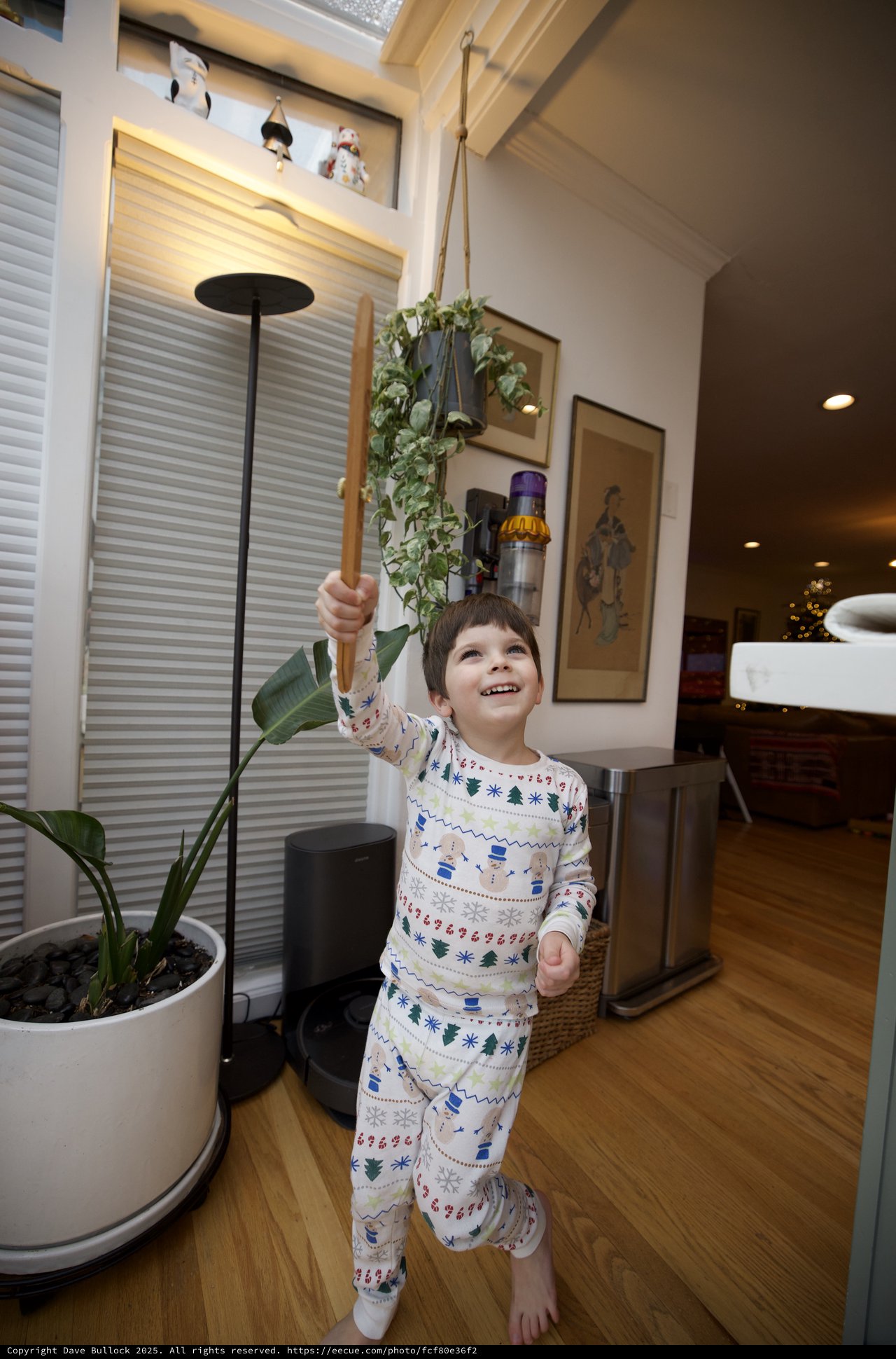 Joyful Child Playing with Wooden Sword in Cozy Home