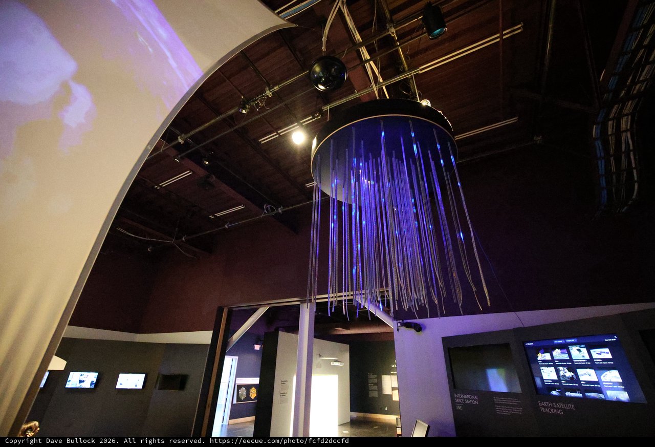 Interactive Space Museum Installation with Purple Fiber Optic Display