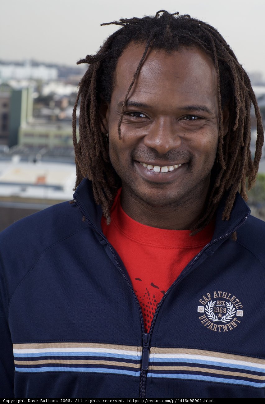 Dreadlocked Man Smiling By Waterfront