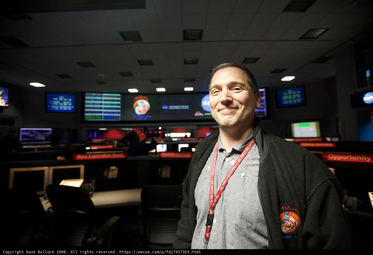 Man in Front of 8 Monitors