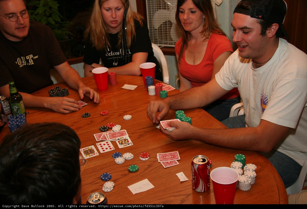 Friends Enjoy Casual Home Poker Night with Drinks