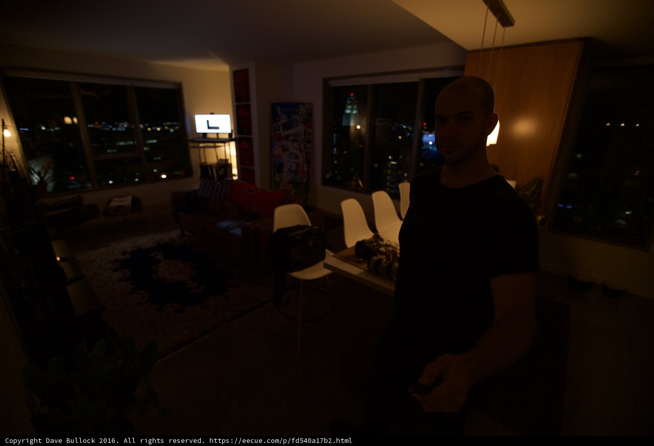 Moody interior shot of a man in a dark room