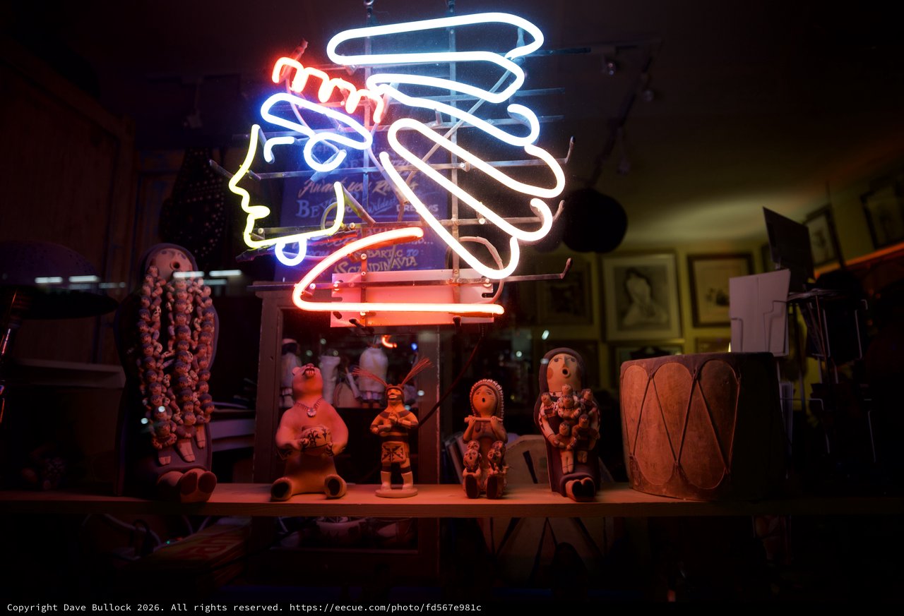 Neon Kokopelli Display with Pueblo Pottery and Folk Art