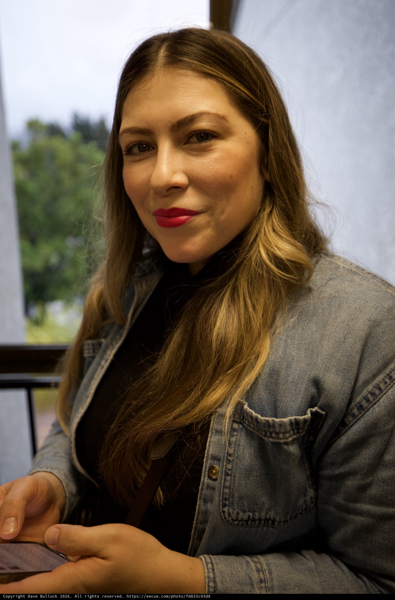 Portrait of Woman in Denim Jacket at Indoor Setting