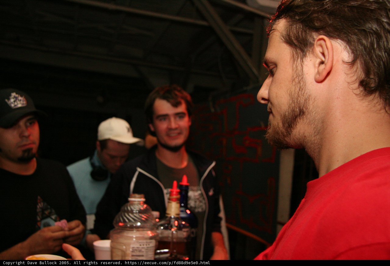 Red-Shirted Man Enjoying a Drink at the Bar