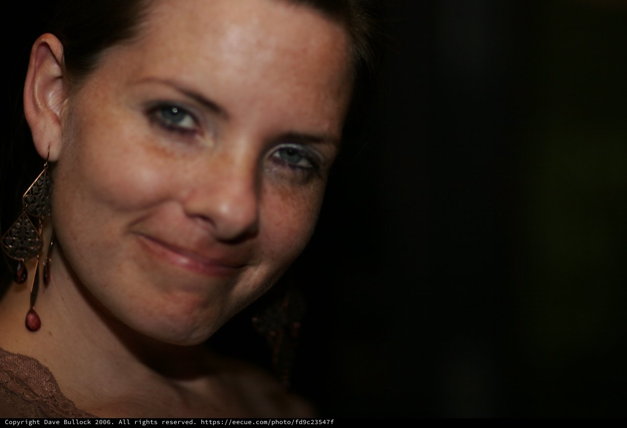 Penelope's Coy Smile in Dramatic Low Light
