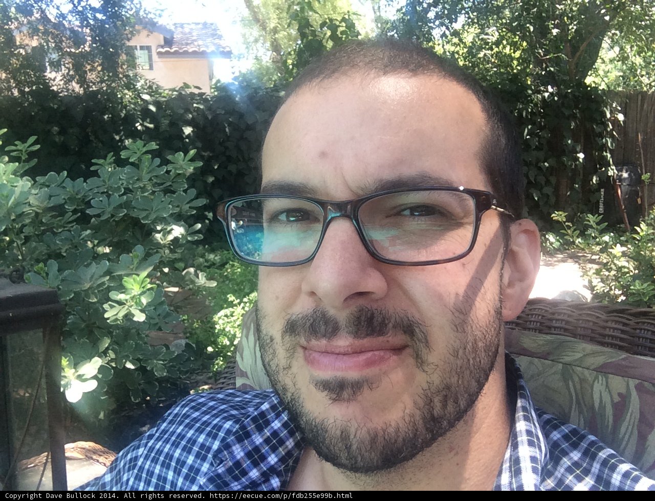 Smiling Man with Glasses and Beard in the Garden
