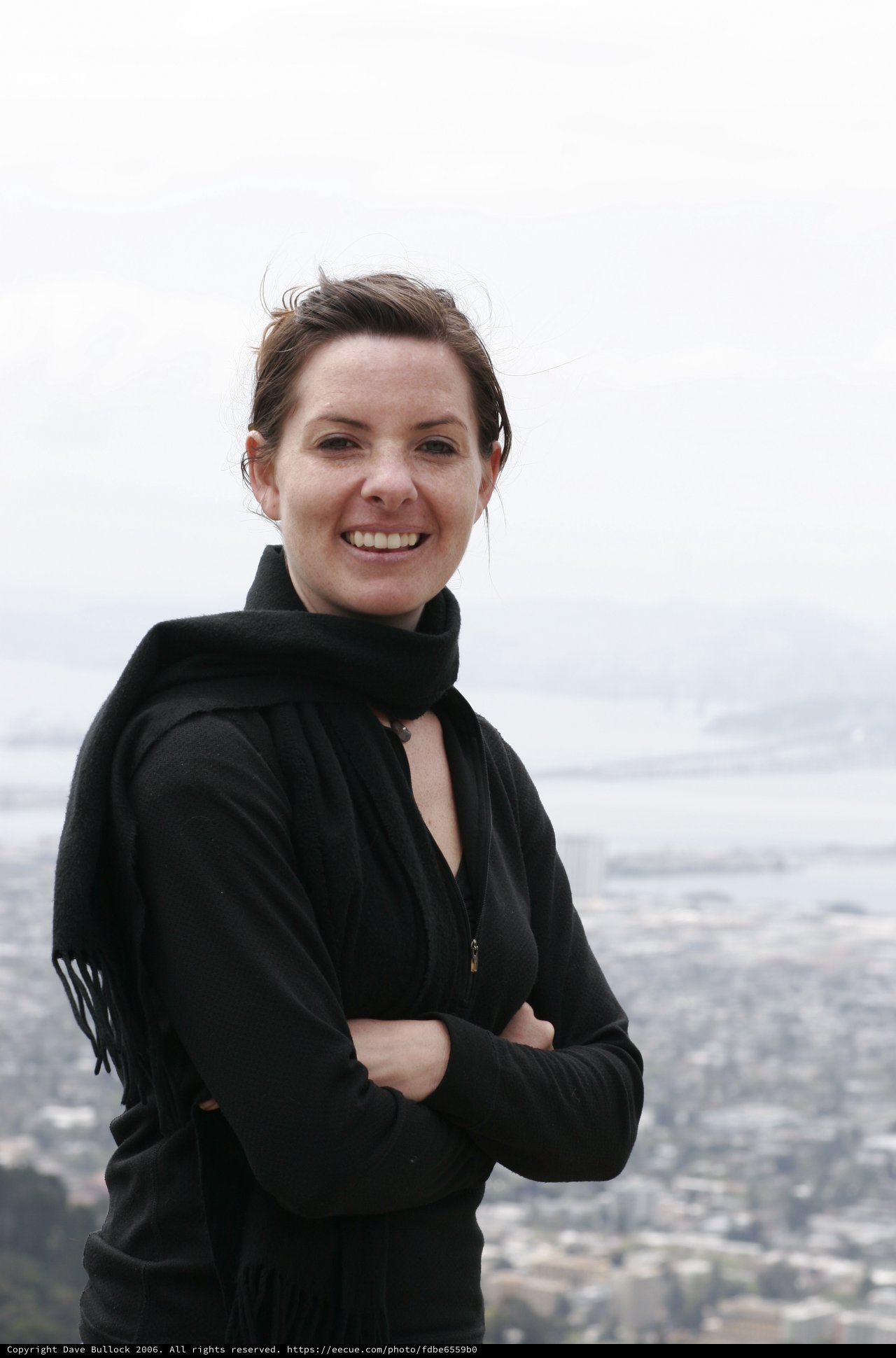 Smiling Woman Atop San Francisco's Twin Peaks