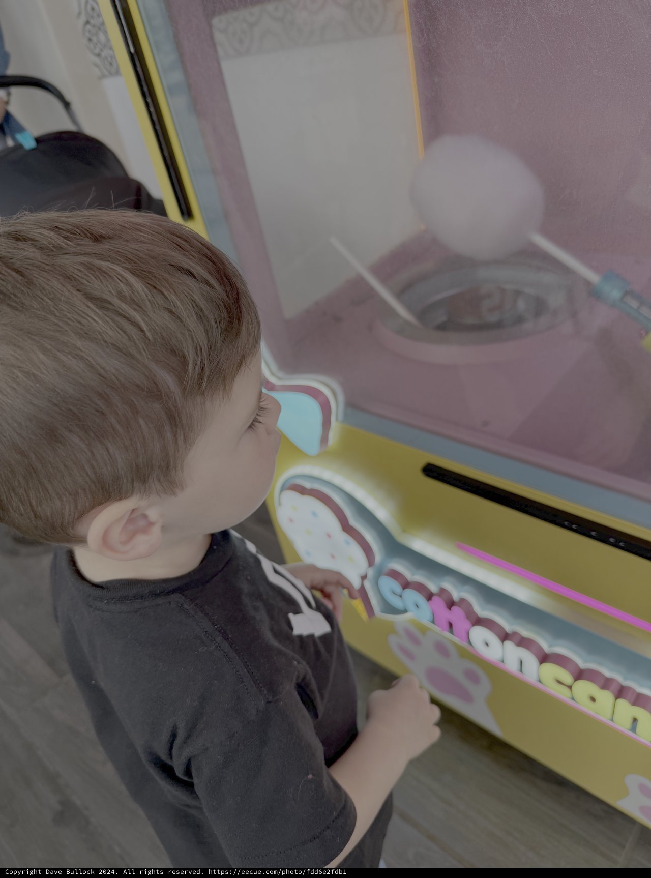 Child Playing Arcade Game at Entertainment Center