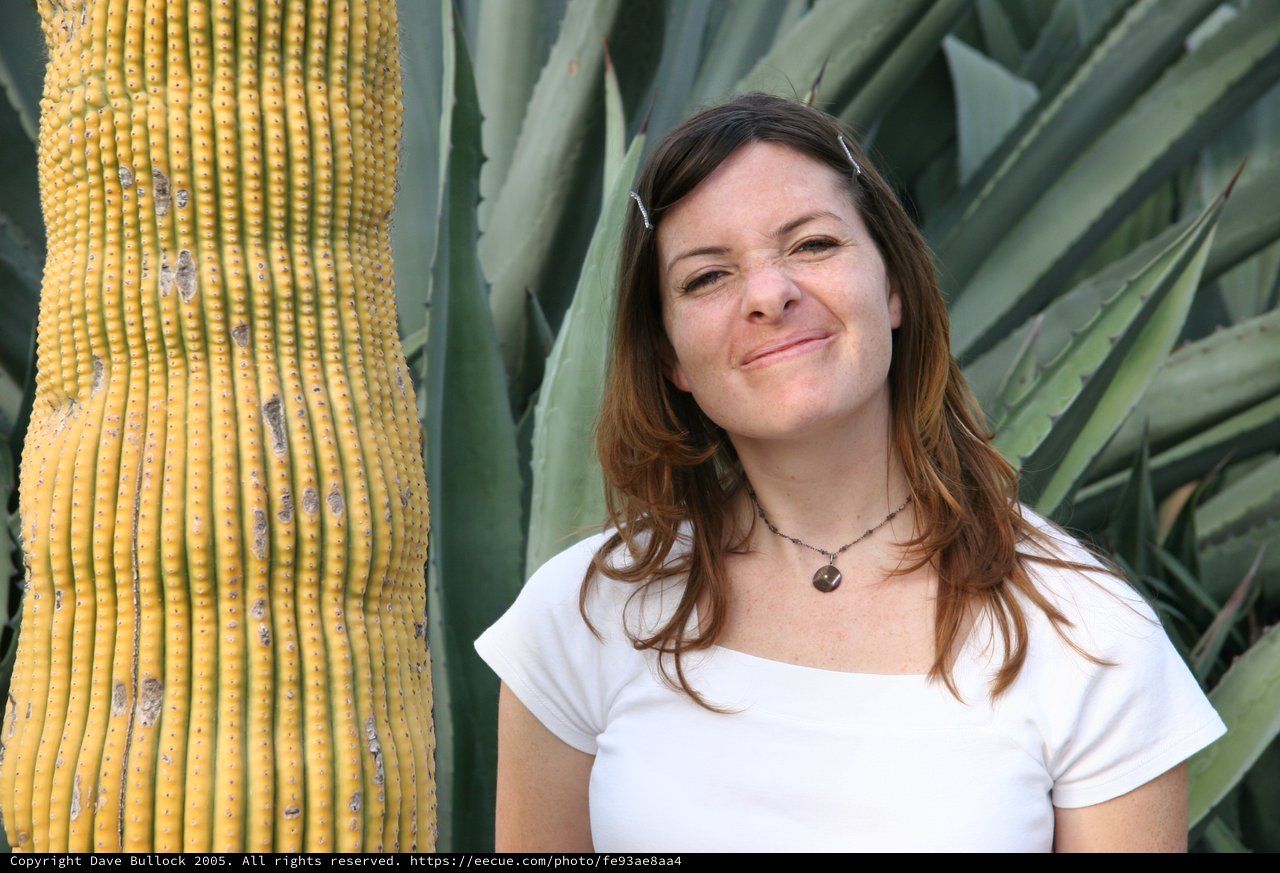 Smiling Woman Beside Desert Cactus and Agave